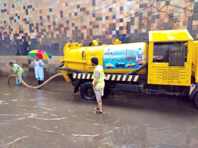 wasa workers pump out rainwater accumulated at committee chowk in rawalpindi photo express file