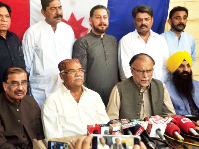 pml n secretary general ahsan iqbal addresses a press conference with sindh taraqi pasand party chairman qadir magsi photo ppi