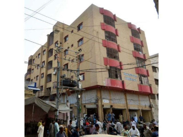 residents of makkah terrace stand outside the building in distress face to face with sbca offiicials who had come to demolish the building on court orders photo express residents of makkah terrace stand outside the building in distress face to face with sbca offiicials who had come to demolish the building on court orders photo express