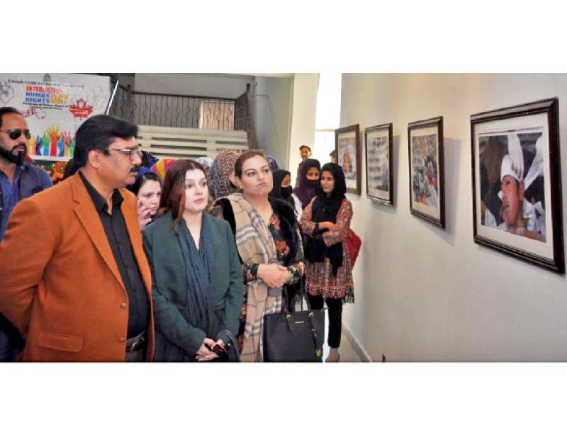 peace and culture organisation chairperson mushaal hussein mallick looks at pictures at an exhibition on kashmiri struggle at rawalpindi arts council photo express