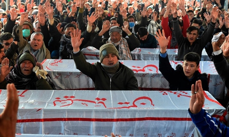 Mourners chant slogans near the coffins of the miners who were killed in an attack by gunmen in the mountainous Mach area, during a sit-in protest at the eastern bypass, on the outskirts of Quetta on January 4. — AFP