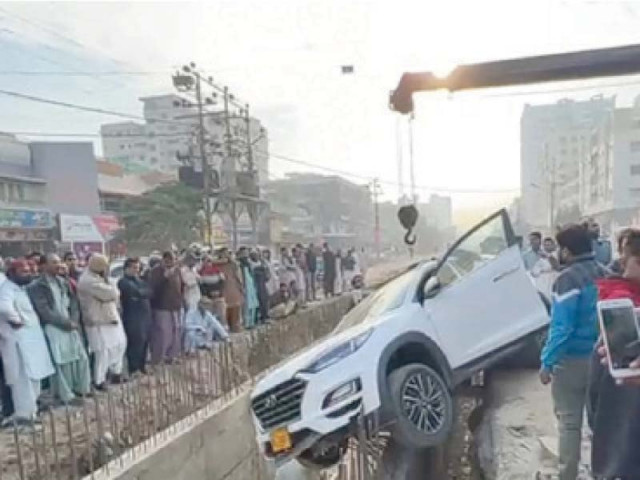 a crane pulls out the suv which fell into an open nullah near north nazimabad food street on wednesday photo express a crane pulls out the suv which fell into an open nullah near north nazimabad food street on wednesday photo express