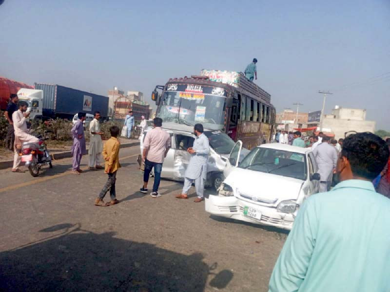 passersby observe the aftermath of a massive road accident and subsequent fire on gt road near okara photo express