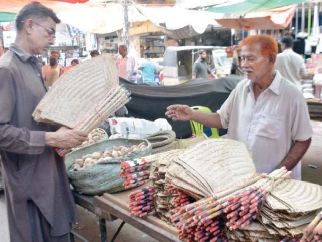 a man buys traditional fans made from date palm leaves as many areas of the city face up to 20 hour long power outages photo jalal qureshi express a man buys traditional fans made from date palm leaves as many areas of the city face up to 20 hour long power outages photo jalal qureshi express