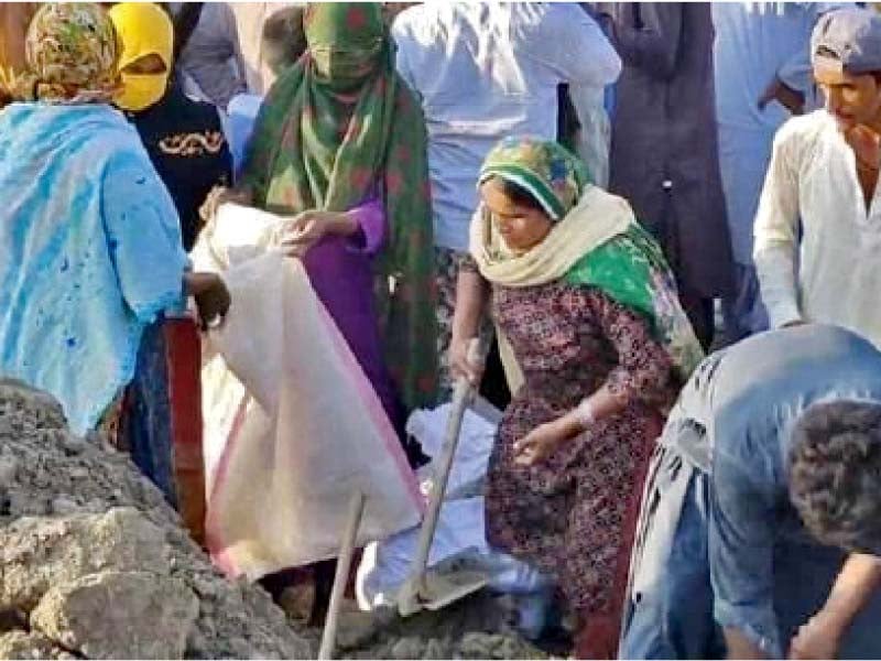 women help in building dykes in the juhi town as floodwaters continue to rise photo express