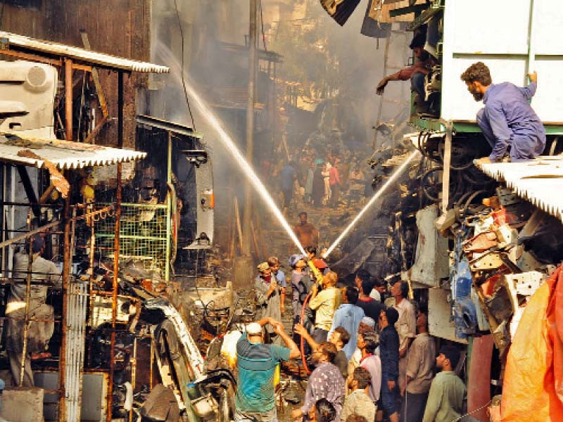 firefighters struggle to douse flames after a fire broke out in shershah junk market on thursday morning photo online