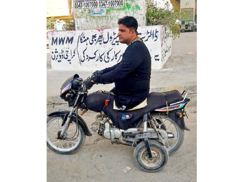 tahir abbas sits on his improvised motorcycle he uses to haul commuters for a ride hailing service photo express