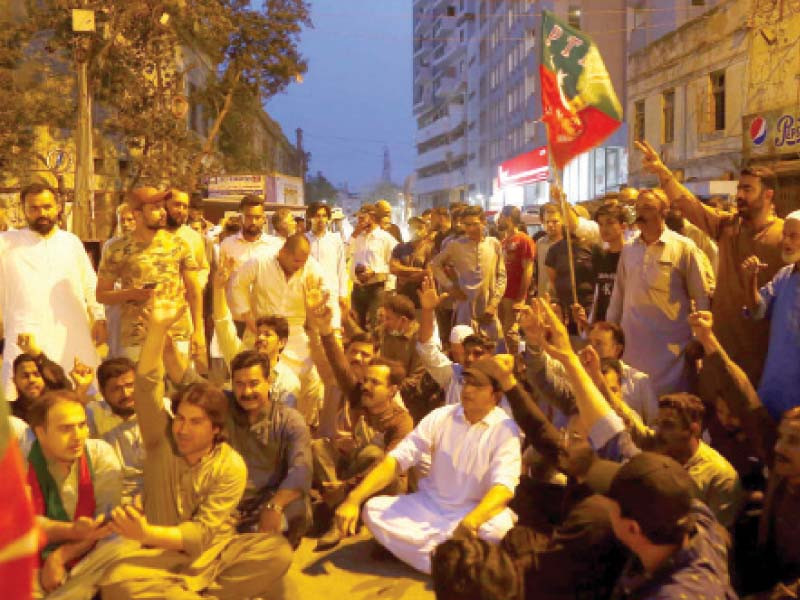 people stage protest at shaheen complex intersection on ii chundrigar road against attempts to arrest pti chairman imran khan photo ppi