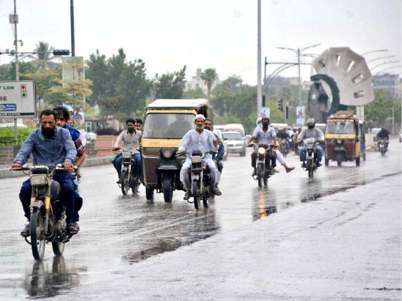 people head to work during light rain on wednesday morning photo jalal qureshi express