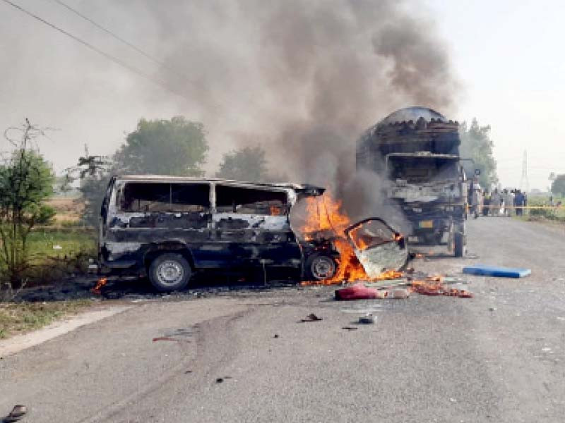 the burning wreck of a passenger van sits at the side of a road following a deadly road crash photos express