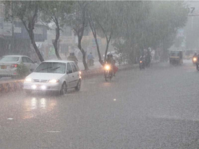 commuters drive through rain on a road photo express file commuters drive through rain on a road photo express file