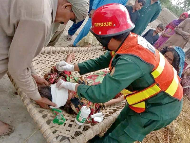 rescue personnel tend to a victim of the blast photo express