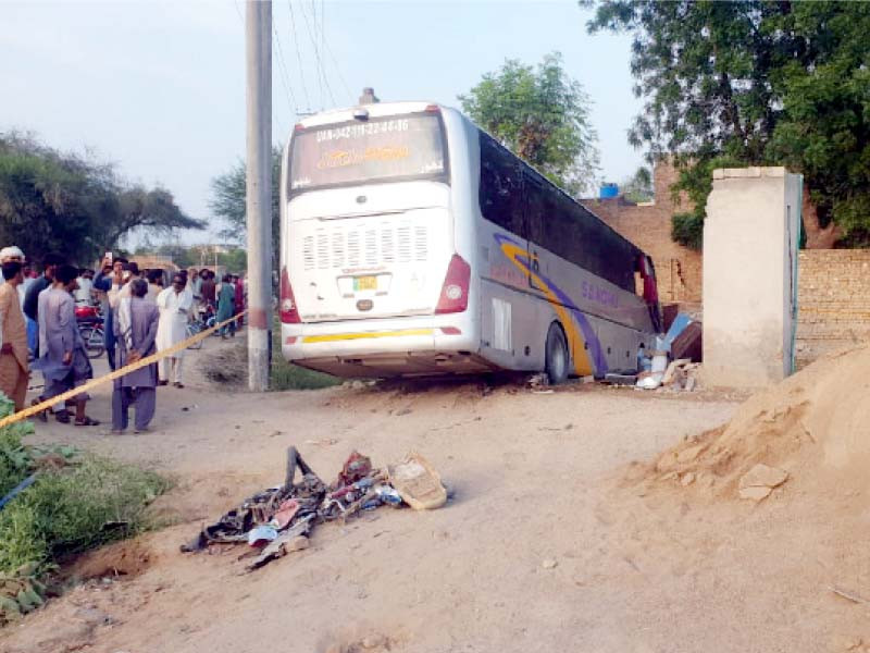 the mangled crushed remains of a motorcycle can be seen after it was run over by the bus near basti kamalaywala photo express