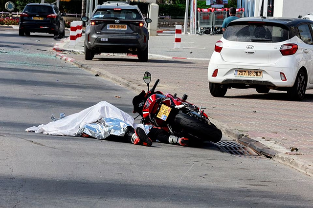 The body of a motorist lies on a road following a mass-infiltration by Hamas gunmen from the Gaza Strip, in Sderot, southern Israel October 7. REUTERS