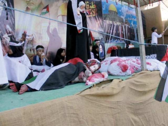 women and children present a tableau to highlight the situation in gaza during a rally held under the banner of nasiran e palestine photo ppi women and children present a tableau to highlight the situation in gaza during a rally held under the banner of nasiran e palestine photo ppi