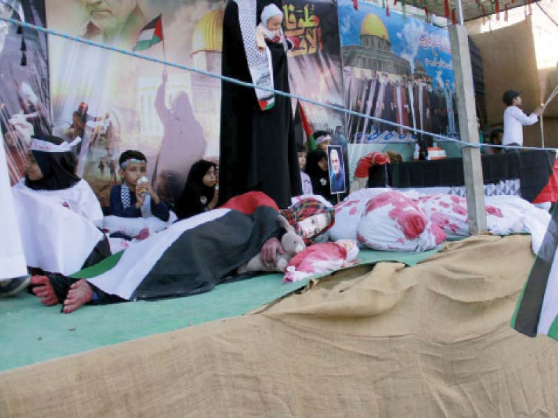 women and children present a tableau to highlight the situation in gaza during a rally held under the banner of nasiran e palestine photo ppi