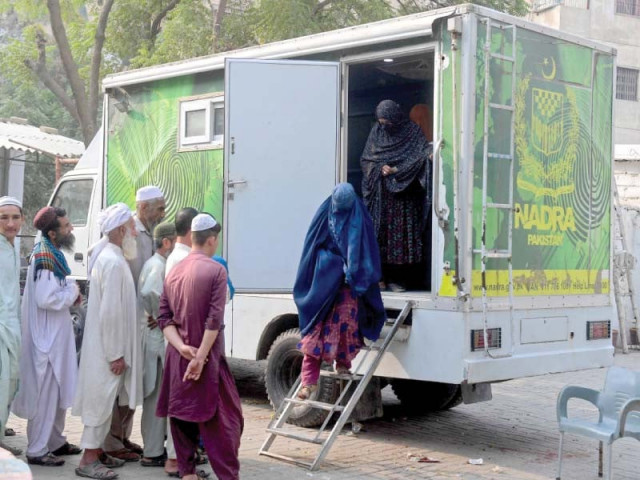 afghan women walk out of a national database and registration authority nadra van after their data verification at a police station in karachi on wednesday photo afp afghan women walk out of a national database and registration authority nadra van after their data verification at a police station in karachi on wednesday photo afp