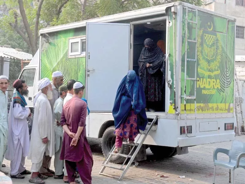 afghan women walk out of a national database and registration authority nadra van after their data verification at a police station in karachi on wednesday photo afp afghan women walk out of a national database and registration authority nadra van after their data verification at a police station in karachi on wednesday photo afp