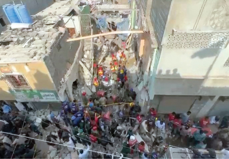 a lone beam remains dangling between two buildings while rescue workers look for survivors in the debris of the house which collapsed due to explosion at the lpg decanting shop on its ground floor photo express