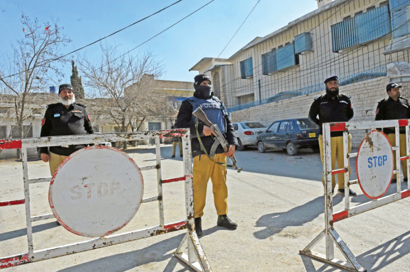 policemen stand guard outside the provincial election commission office ahead of the upcoming general elections in quetta photo afp