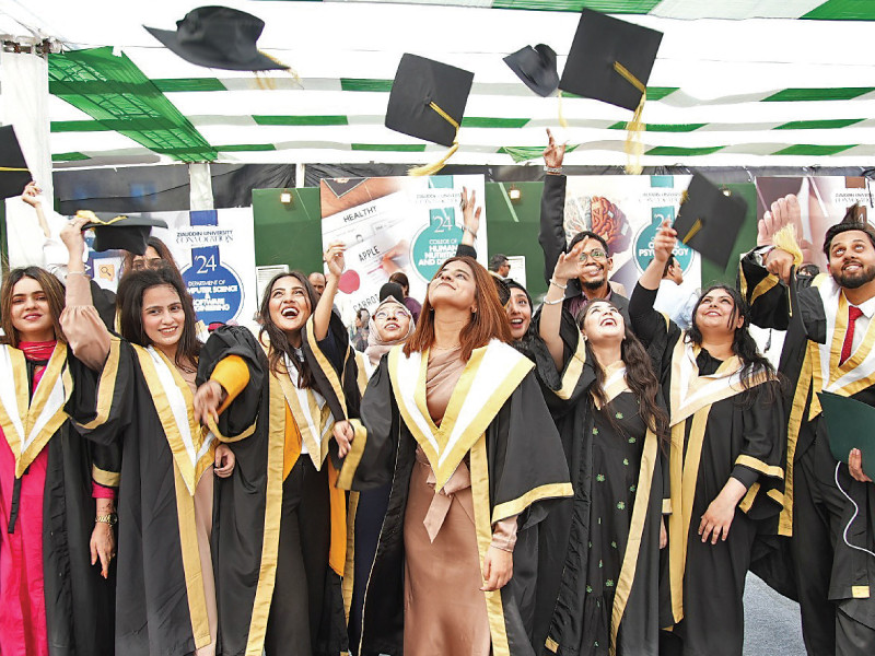 passing out students toss their graduation hats in the air after receiving degrees photo express