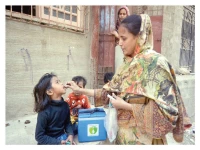 a lady health worker administers polio vaccine to a child in a karachi neighbourhood on monday photo jalal qureshi express