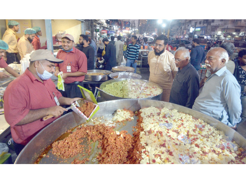 winter delight a sweet shop employee sells gajar ka halwa a traditional sweet dish prepared with grated carrots sugar ghee milk milk solids and dry fruits photo jalal qureshi