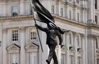 banksy owns up to statue of man blinded by flag
