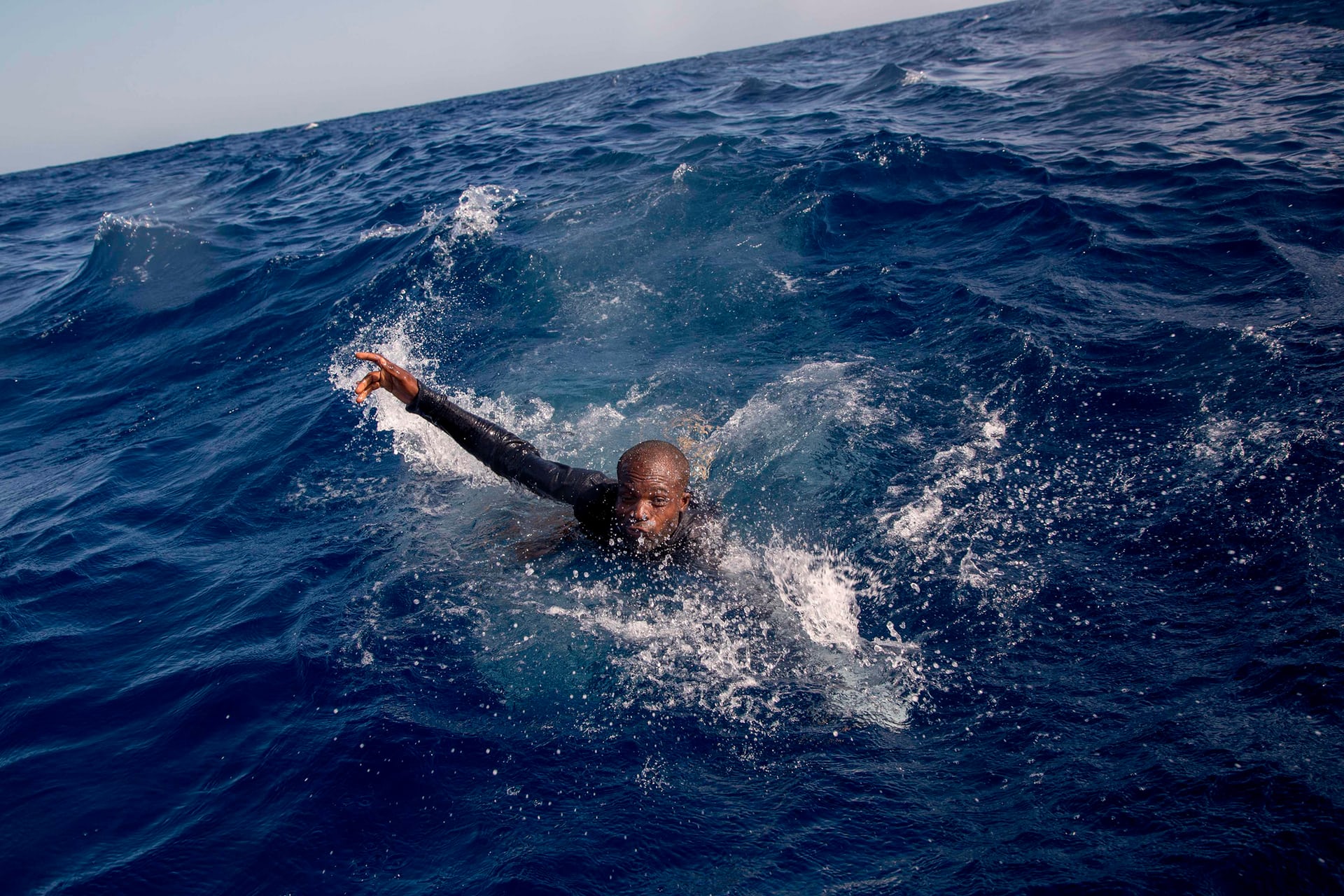 a migrant tries to board a boat belonging to the german non governmental organisation sea watch a shipwreck resulted in the death of five people including a newborn child mediterranean sea photo afp