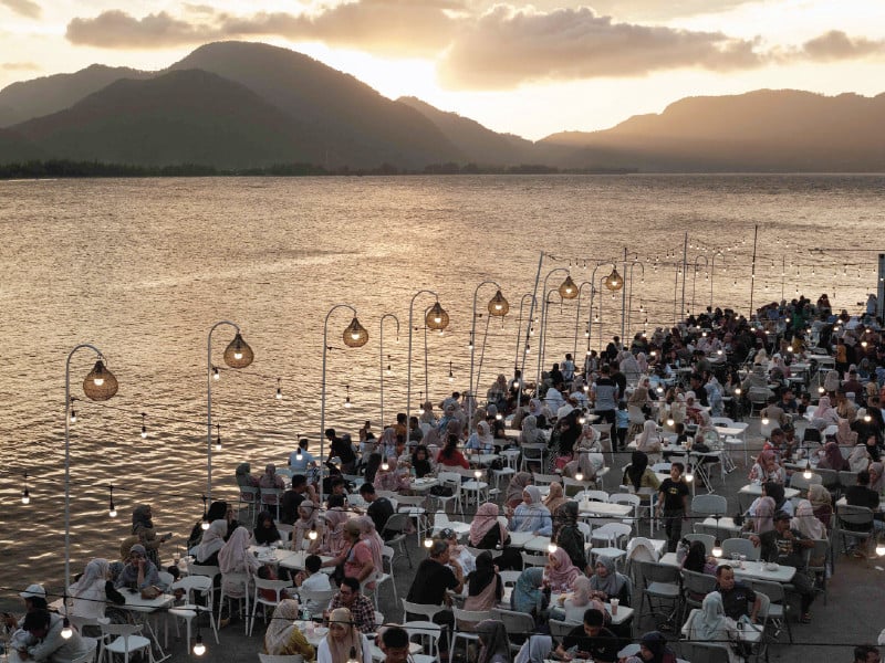 people enjoy an oceanfront cafeteria built on the site where all houses were destroyed by the 2004 indian ocean tsunami in banda aceh photo afp