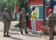 security personnel stop a delivery man as they stand guard along a road in kolkata photo reuters