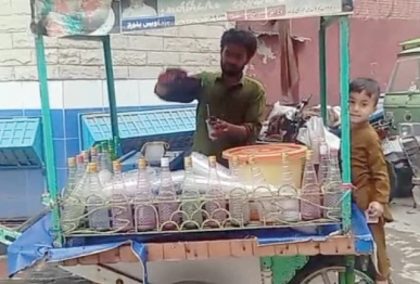 summer treat caveat a vendor sells flavoured ice balls to children at his stall in a rawalpindi neighbourhood photo express