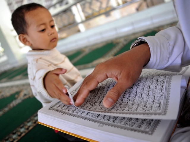 A man reads the Quran at a mosque on the first day of the fasting month of Ramazan in Denpasa,r on Indonesia's resort island of Bali on July 21, 2012. PHOTO: AFP