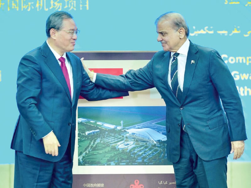 pm shehbaz sharif and his chinese counterpart li qiang gesture after unveiling a plaque to mark the completion of new gwadar international airport during a ceremony at the prime minister house in islamabad photo afp