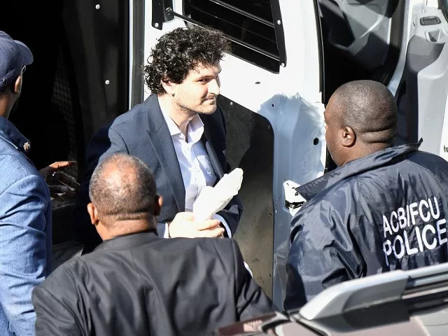 sam bankman fried the founder and former ceo of crypto currency exchange ftx is escorted into the magistrate court building in nassau bahamas december 21 2022 photo reuters