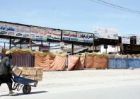 a man pushes a wheelbarrow past a bus terminal temporarily shut by authorities over security concerns photo online