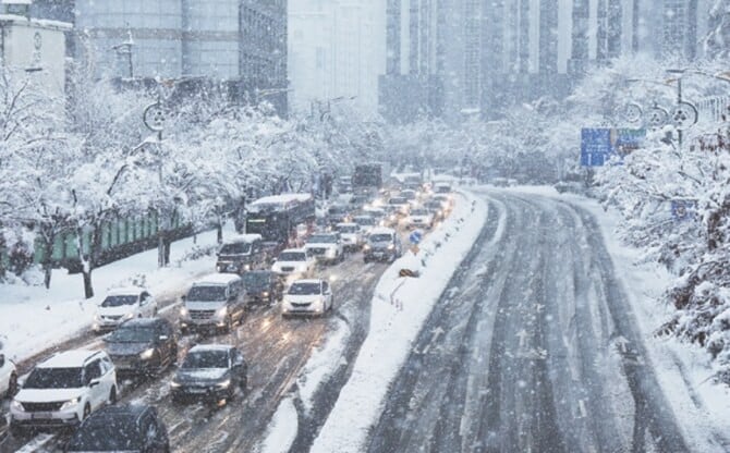 cars move slowly on a road during heavy snowfall in south korea photo ap