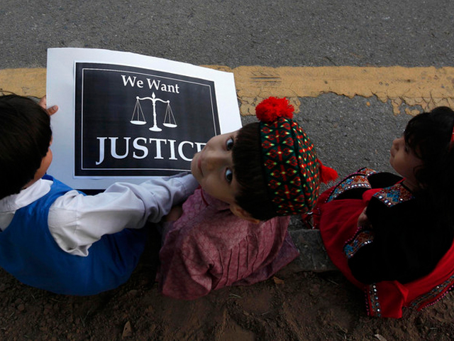 children sit with a placard on a roadside during a protest by members of a civil society against the rape of a five year old girl in lahore in islamabad photo reuters