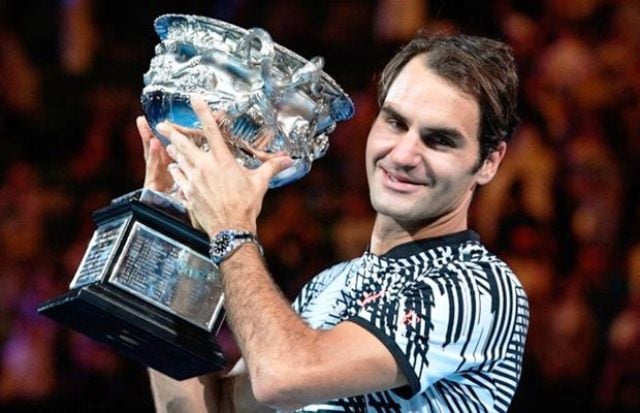 switzerland 039 s roger federer celebrates with the championship trophy during the awards ceremony after his victory against spain 039 s rafael nadal in the men 039 s singles final of the australian open in melbourne on january 29 2017 photo afp william west