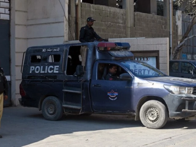 police officers stand guard outside a factory where according to police two chinese nationals were shot and injured in karachi pakistan on november 5 2024 photo afp