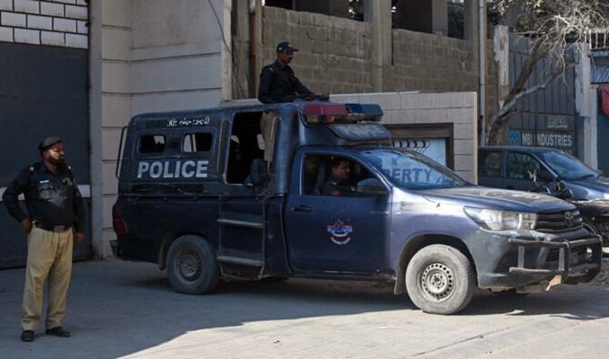 police officers stand guard outside a factory where according to police two chinese nationals were shot and injured in karachi pakistan on november 5 2024 photo afp