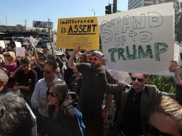 protesters hold signs during a demonstration against u s president donald trump outside the office of sen dianne feinstein d ca on january 31 2017 in los angeles california photo afp protesters hold signs during a demonstration against u s president donald trump outside the office of sen dianne feinstein d ca on january 31 2017 in los angeles california photo afp