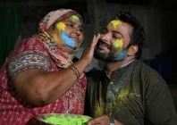 a mother paints the face of her son as they celebrate holi in mithi tharparkar district of sindh on march 13 2025 photo afp