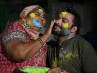 a mother paints the face of her son as they celebrate holi in mithi tharparkar district of sindh on march 13 2025 photo afp