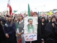 a woman holds a poster depicting iran s new supreme leader mojtaba khamenei during a rally in tehran photo reuters
