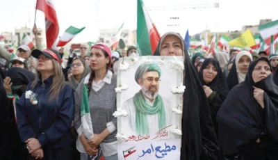 a woman holds a poster depicting iran s new supreme leader mojtaba khamenei during a rally in tehran photo reuters