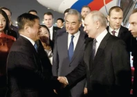 russia s president vladimir putin shakes hands with china s ambassador to russia zhang hanhui as foreign minister wang yi stands nearby during a welcoming ceremony at an airport in beijing photo reuters