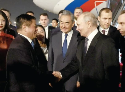 putin arrives in china for talks with long time friend xi