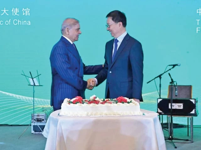 prime minister shehbaz sharif shakes hands with chinese vice president han zheng as they prepare to cut a cake to mark 75 years of diplomatic relations between the two countries in beijing photo express prime minister shehbaz sharif shakes hands with chinese vice president han zheng as they prepare to cut a cake to mark 75 years of diplomatic relations between the two countries in beijing photo express