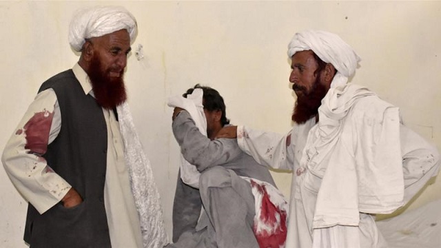 Men mourn the death of relatives and friends at hospital morgue in Quetta. PHOTO: REUTERS 